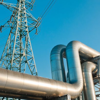 A,Close-up,Of,A,Pipeline,And,A,Power,Transmission,Tower